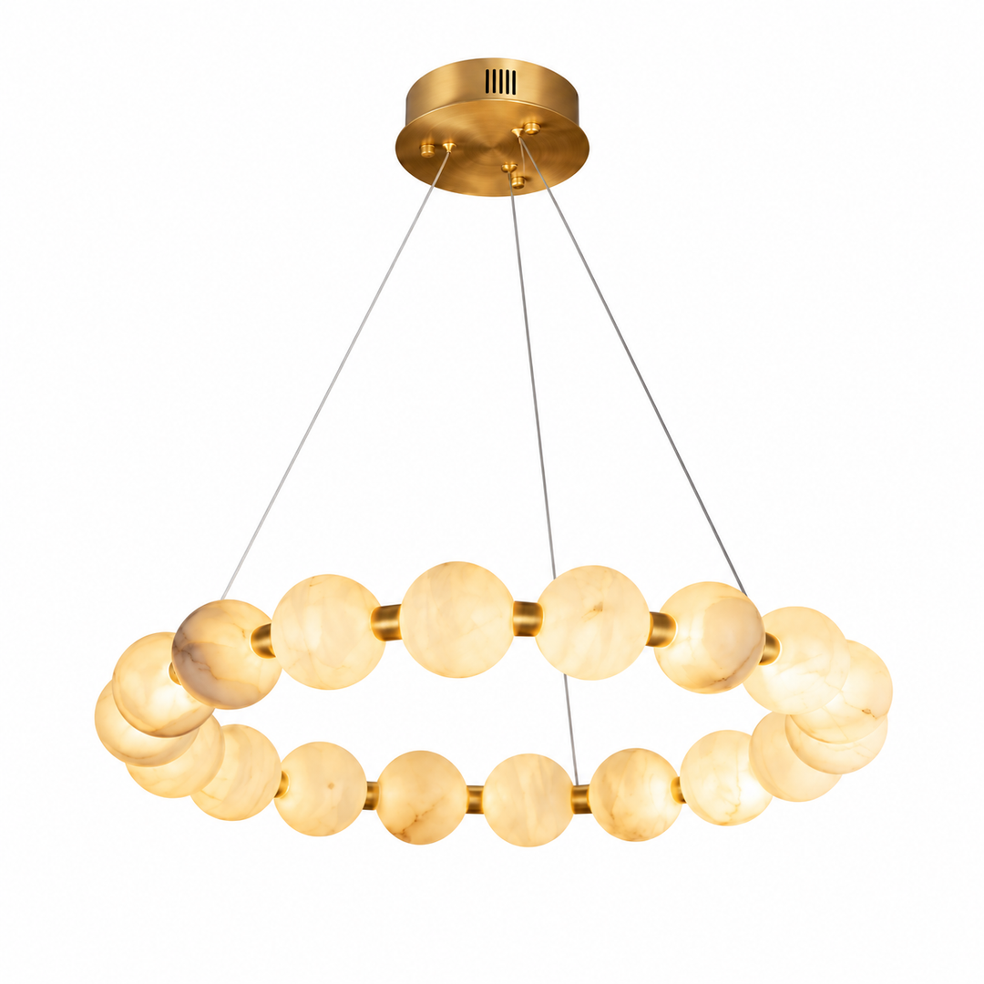 An illuminated alabaster ring chandelier with gold-tone metal and thin suspension cables hangs against a white background.