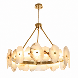 A modern multi-light chandelier with a brushed gold metal frame and circular pendant lights made of natural white agate flakes, shown against a solid white background.