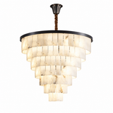 A modern tiered chandelier light fixture with warm white stone or bone disc panels, a black circular frame, and a dark metal ceiling canopy with a brown rope cord, shown on a plain white background.