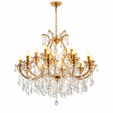A gold-finished multi-light crystal chandelier with ornate curved arms, clear hanging teardrop crystals, and illuminated candle-style bulbs, shown against a plain white background.