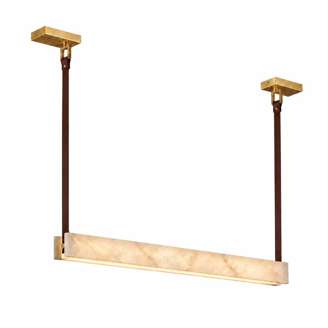 A modern linear pendant light fixture with a brushed gold metal frame and ceiling mounts, dark brown hanging rods, and a rectangular warm white marble diffuser, shown against a solid white background.