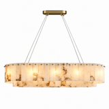 Illuminated oval alabaster chandelier with two tiers of veined cream panels, suspension cables, and a gold-tone ceiling canopy against a white background.