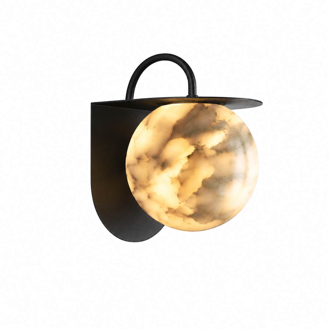 A modern wall-mounted sconce with a matte black metal frame and a spherical glass shade featuring a warm, cloudy cream and gold marbled pattern, shown against a plain white background.