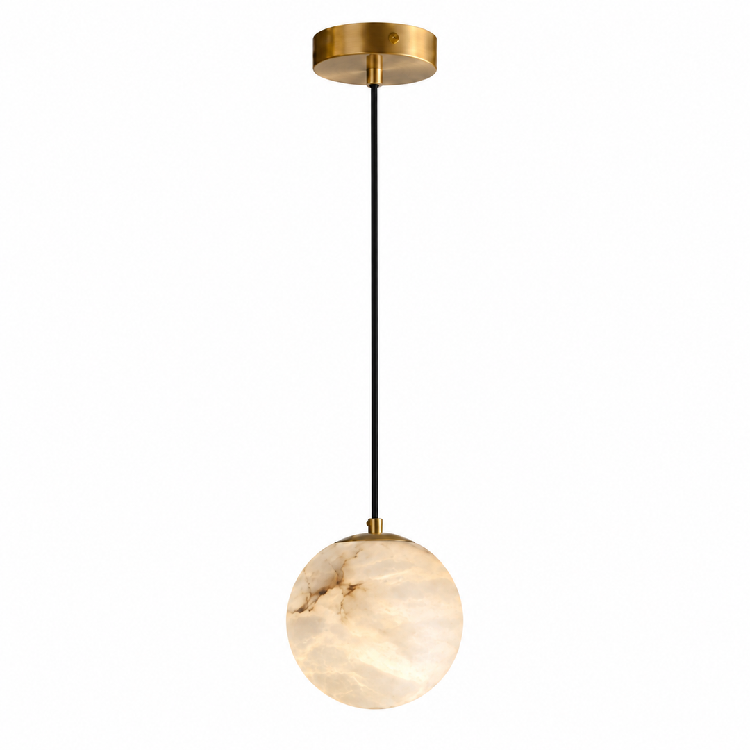 A modern pendant light with a round, glowing warm-white marble globe shade, suspended by a thin black cord from a brushed gold ceiling canopy.