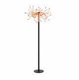A modern floor lamp with a slim black pole and circular base, topped with a spherical cluster of orange wires or cords ending in small dark tips, shown on a plain white background.