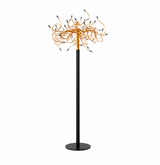 A modern floor lamp with a slim black pole, round base, and a cluster of tangled orange wire-like elements at the top, each ending in small black and silver bulb tips, shown on a plain white background.