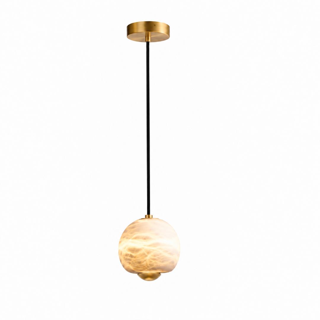 A modern pendant light fixture with a textured, warm-toned glass globe shade, suspended by a black cord from a brushed gold ceiling canopy.