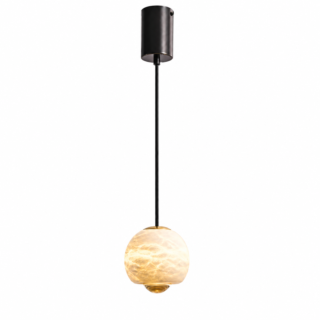 A modern pendant light with a cylindrical black ceiling canopy, a slim black cord, and a glowing warm white textured glass globe shade with gold-toned metal accents.