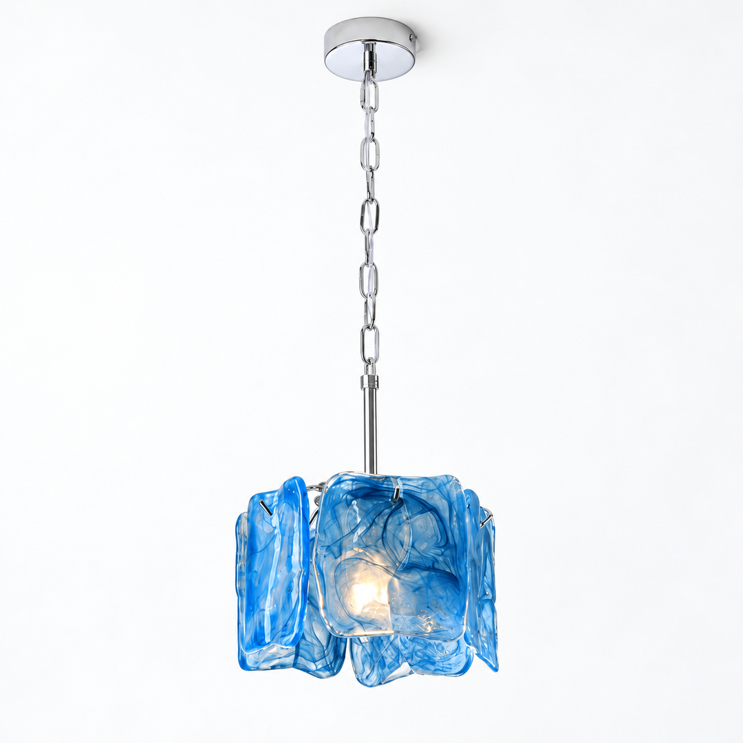 A modern pendant light fixture with a textured, wavy blue glass shade and a polished silver metal chain and canopy, shown against a plain white background.