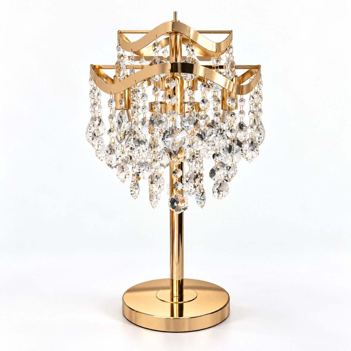 A gold-finished table lamp with a tiered crystal chandelier design, featuring clear faceted hanging prisms on a round base, photographed against a seamless white background.