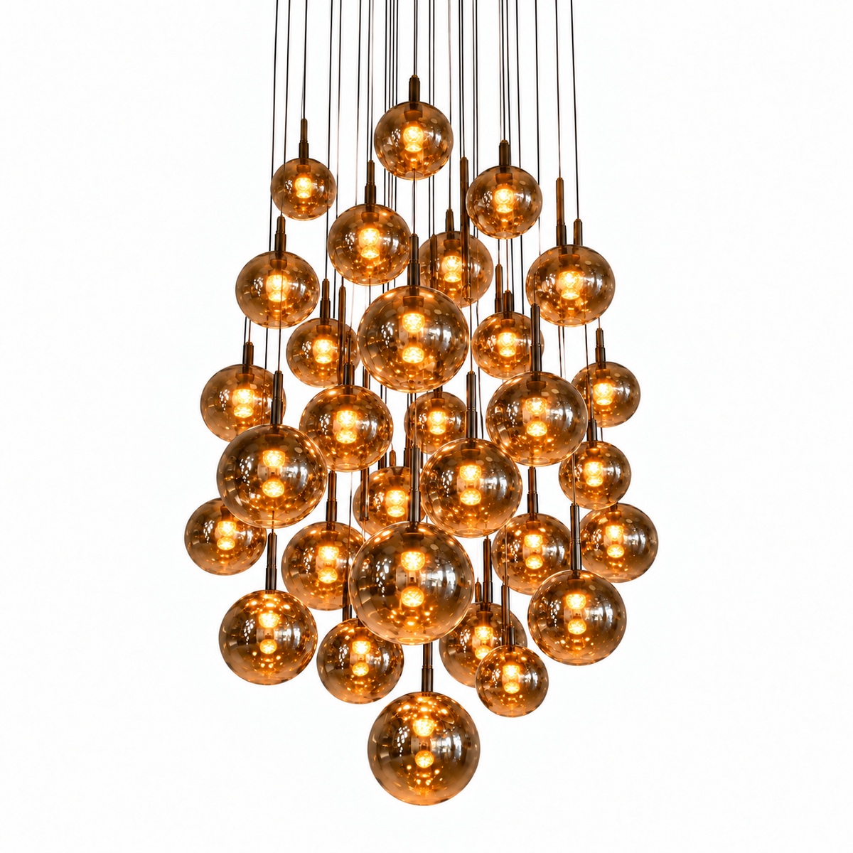 A cluster chandelier featuring multiple amber-tinted glass globe bulbs suspended from a central brass-toned metal frame against a solid white background.