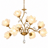 A 10-light chandelier with a gold-finished metal frame, featuring white frosted glass flower-shaped bulbs and clear hanging crystal accents, shown against a solid white background.