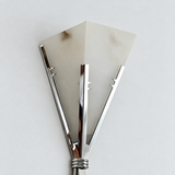 Close-up of a wall sconce with angular off-white alabaster panels and polished stainless steel supports against a pale wall.
