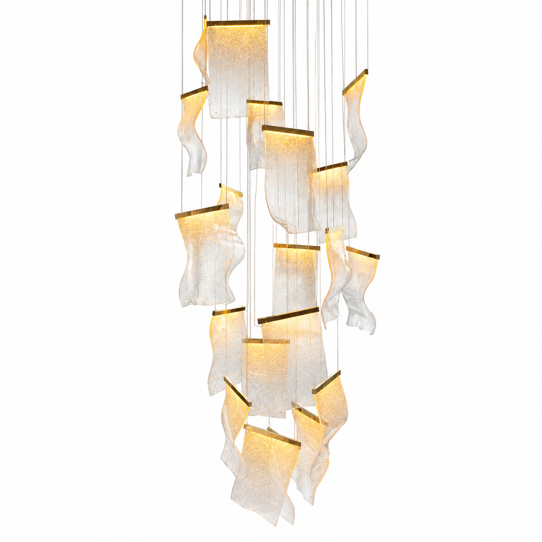 A modern multi-light linear chandelier featuring multiple wavy, translucent white fabric or mesh shades with warm yellow-gold internal lighting, suspended by thin cables against a solid white background.