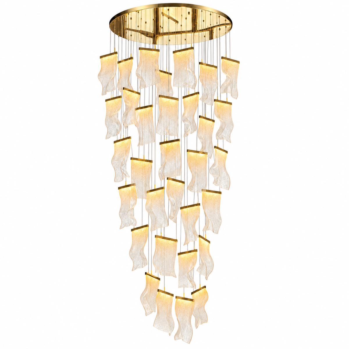 A modern multi-light chandelier with a gold circular ceiling canopy and multiple cascading, wavy glass shades that glow with warm light, shown against a plain white background.