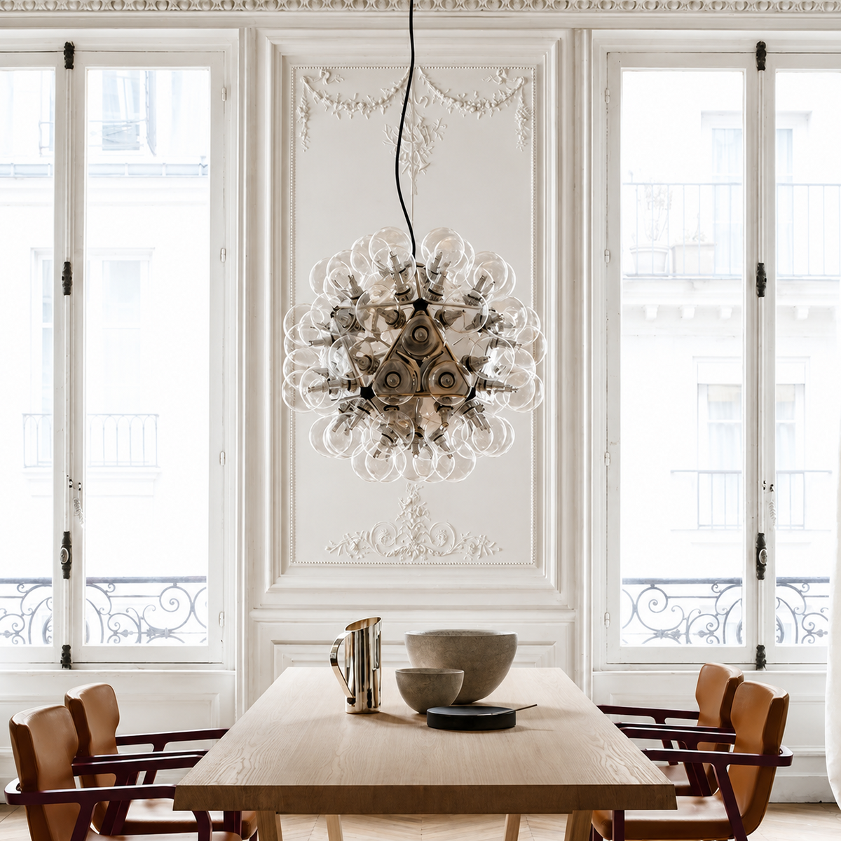Dining room with a decorative chandelier, table, and chairs.