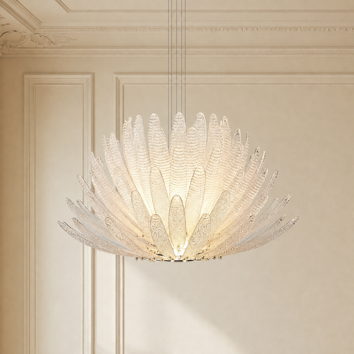 A large, modern flower-shaped pendant chandelier with textured, petal-like clear glass shades, glowing with warm light in an elegant cream-colored room with classic molding.