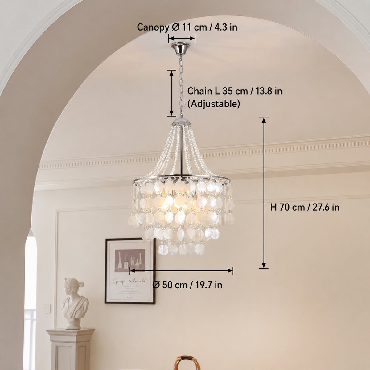 A hanging crystal chandelier shown in a real interior setting with overlaid dimension labels for canopy diameter, chain length, height, and fixture diameter.