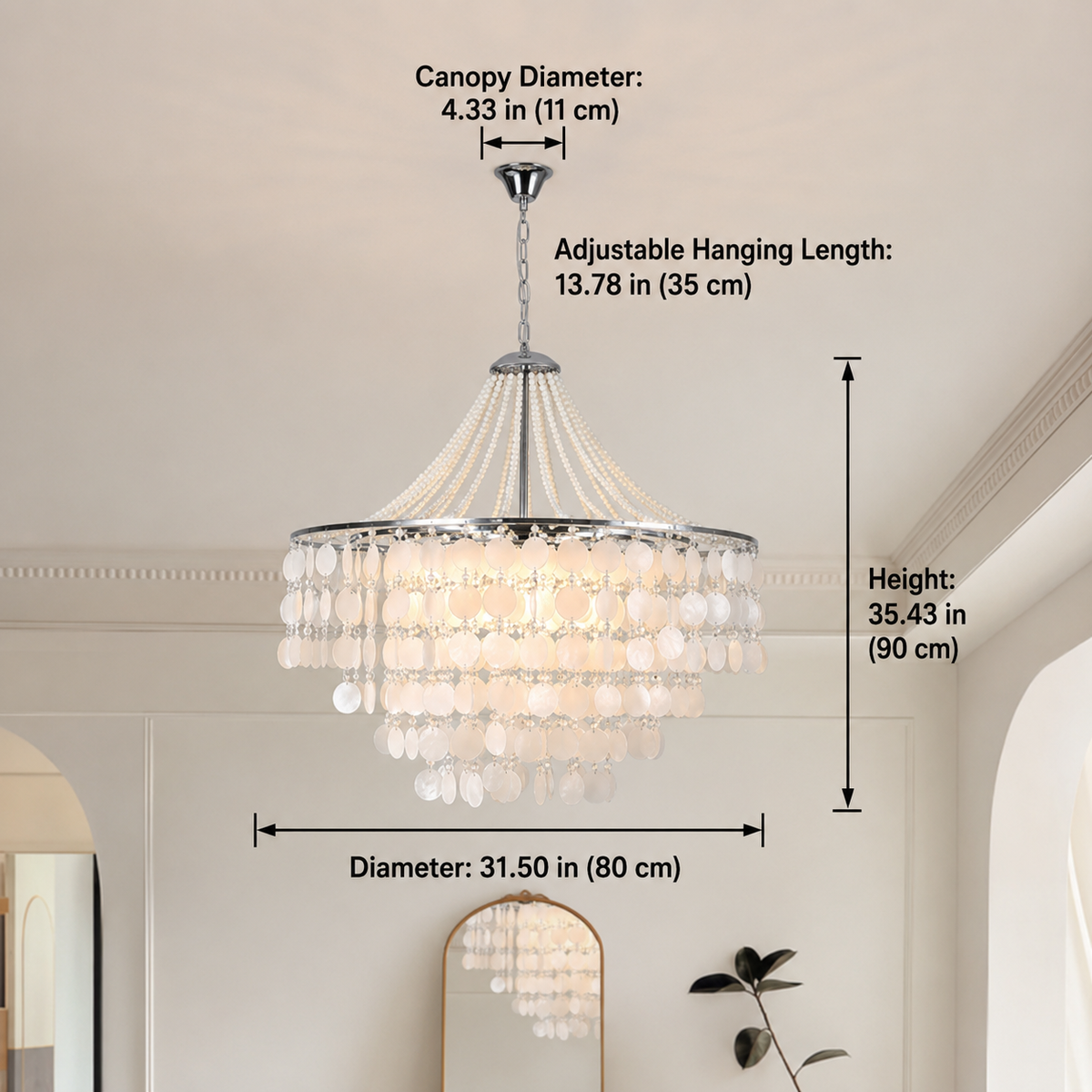 A hanging chandelier with a silver-toned frame, clear crystal beads, and white disc-like accents, shown installed in a room with overlaid dimension labels for canopy diameter, hanging length, and overall height.