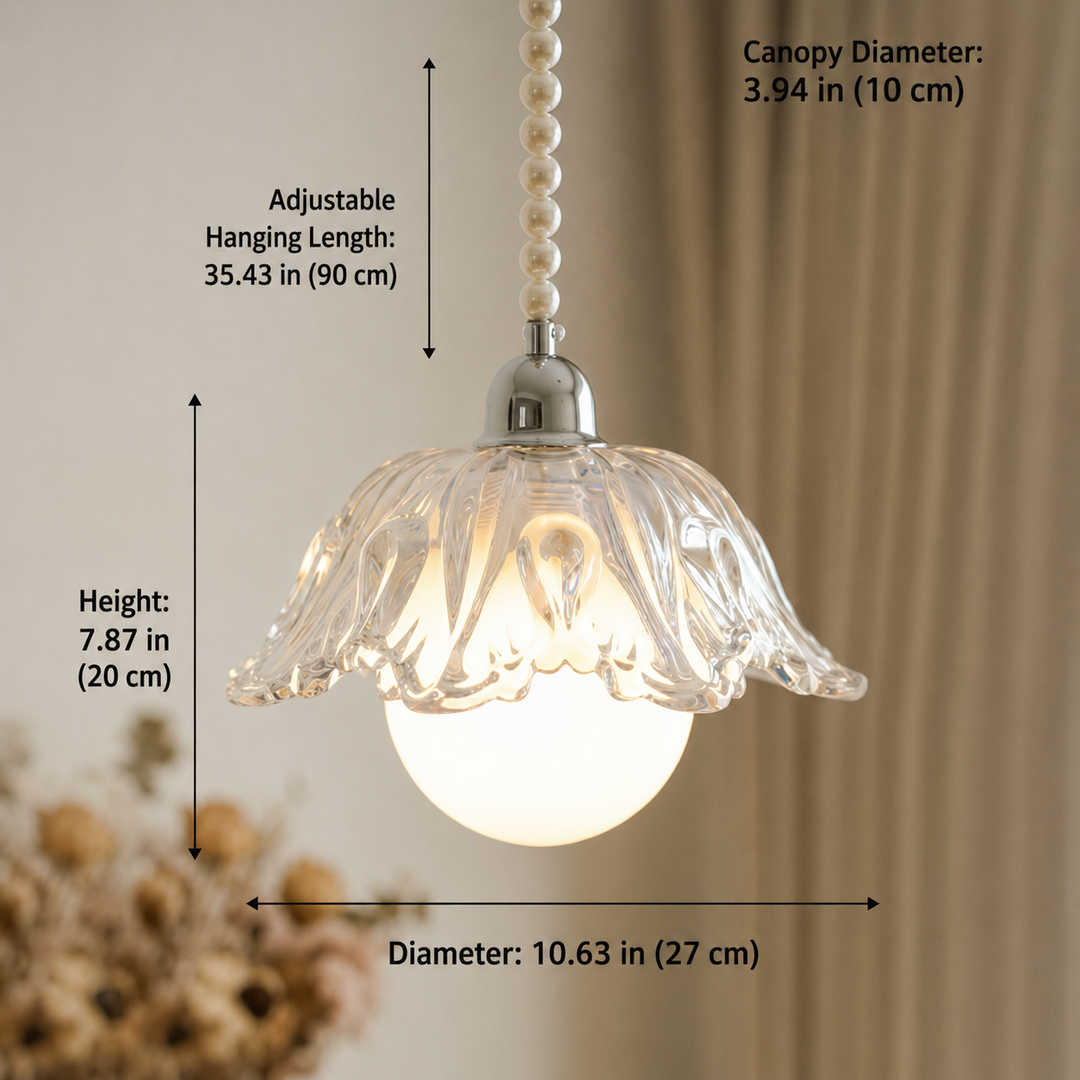 A clear glass flower-shaped pendant light with a glowing white globe bulb, shown with dimension labels for canopy diameter, hanging length, height, and overall diameter against a softly blurred indoor background.