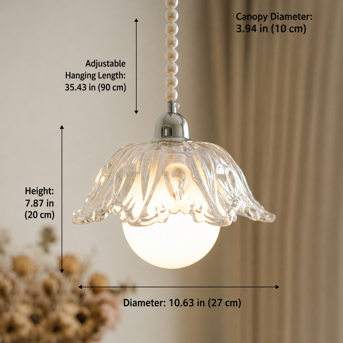 A clear glass flower-shaped pendant light with a glowing white globe bulb, shown with dimension labels for canopy diameter, hanging length, height, and overall diameter against a softly blurred indoor background.