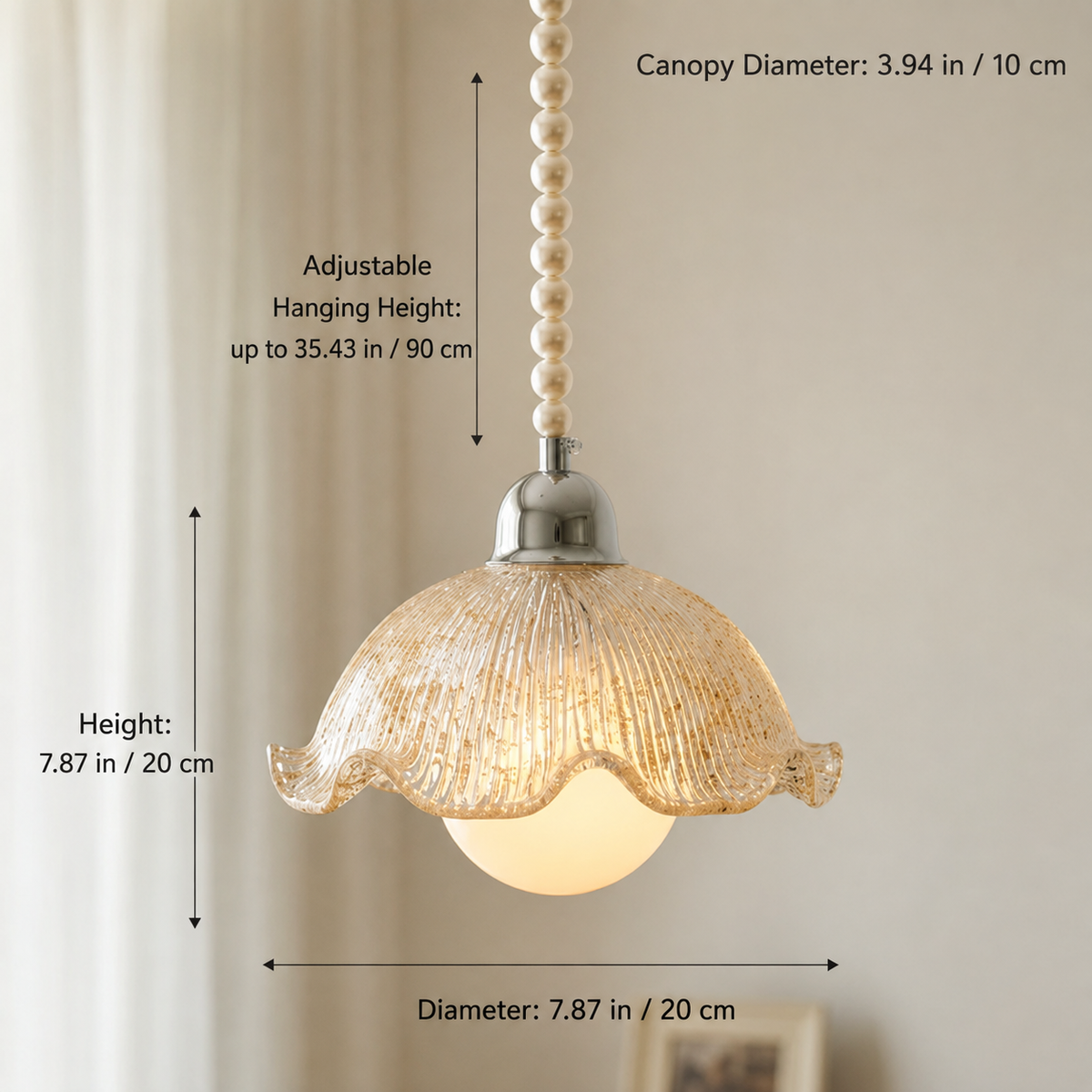 A pendant light with a textured glass shade, a pearl bead chain, and a silver metal cap, shown with dimension lines and text indicating canopy diameter, adjustable hanging height, and shade diameter.