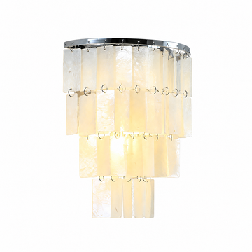 Illuminated wall sconce with tiered cream capiz shell panels and a silver-tone frame against a white background.