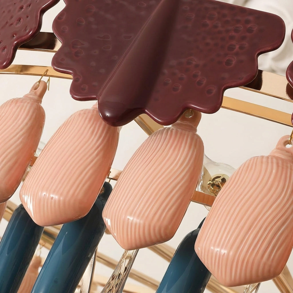 Chandelier close-up shows ribbed peach glass drops, burgundy scalloped pieces, dark blue accents, and a gold-colored frame.