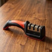 Chef knife being pulled heel to tip through the fine slot of the sharpener