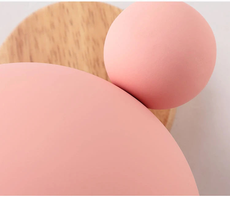 Macro of the pink iron shade, ear ball and wood grain
