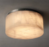 Illuminated alabaster drum flush mount light shows cream stone veining and dark ceiling trim against a gray background.
