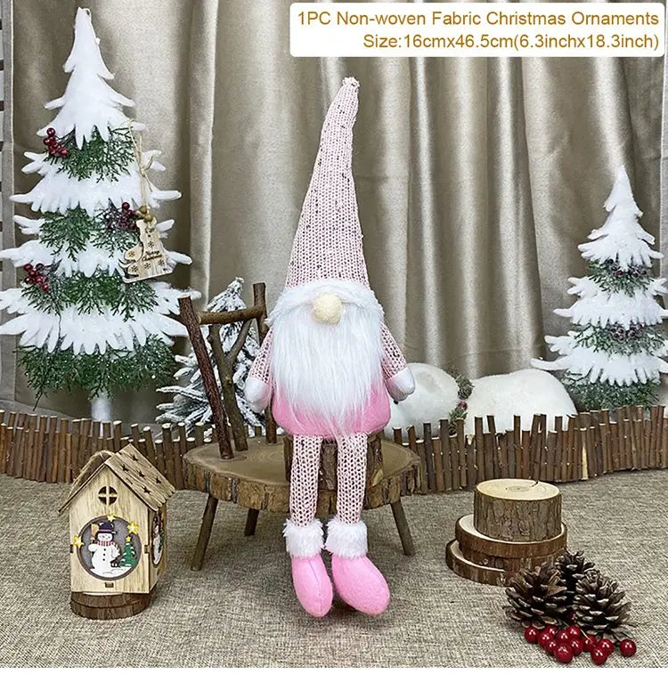 Pink long-legged gnome with a white beard sits on a wooden chair between decorative Christmas trees, with a 16 × 46.5 cm label.