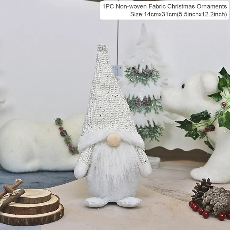 White-bearded gnome with a silver sequined hat stands among white Christmas decorations and wood slices, with a 14 × 31 cm label.