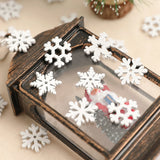 White wood snowflake ornaments decorate the glass and distressed dark frame of a lantern containing a Santa figurine.