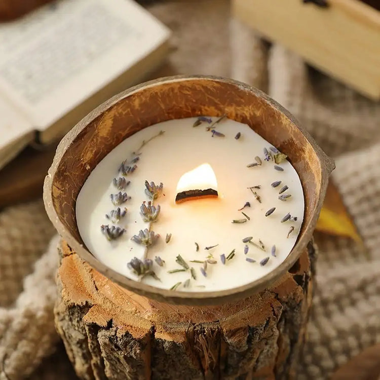 Lavender coconut wax candle burning on a rustic wood slice