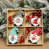 Wooden gnome Christmas ornaments with gray, turquoise, striped red, and plaid hats fill a divided box surrounded by frosted greenery.