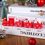 Red Christmas train decoration on a book with measurements displayed