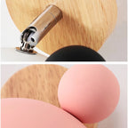 Close-up of the chrome swivel joint and pink shade with rubberwood mount
