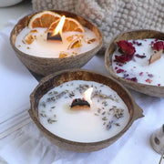 Three lit coconut wax candles showing the wick, with orange and lavender toppings