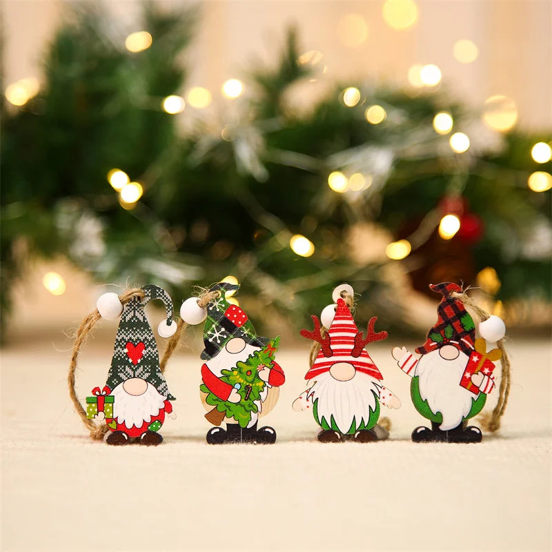 Four red and green gnome ornaments stand on a cream surface against blurred Christmas greenery and warm lights.