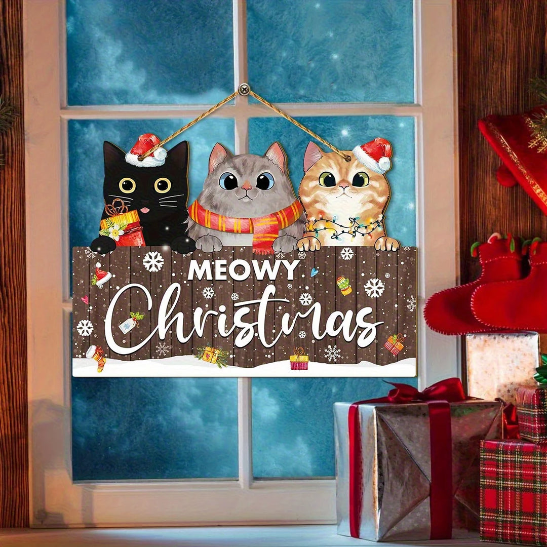 Brown Meowy Christmas hanging sign with three cats hangs against a blue window beside wrapped presents and red stockings.