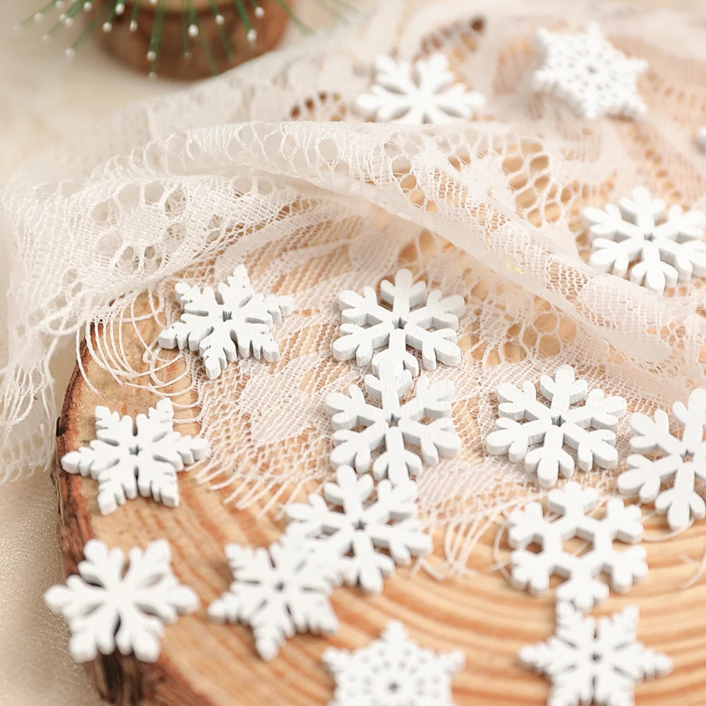 White wood snowflake ornaments in varied patterns rest on folded cream lace draped over a wood slice.
