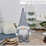 Gray Christmas gnome with a sparkling silver pointed hat and white beard stands beside wood slices, with a 14 × 31 cm label.