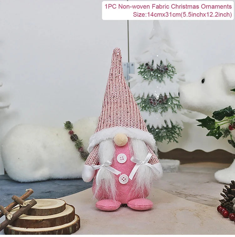 Pink Christmas gnome with a sparkling pointed hat, white braids and two buttons stands beside wood slices, with a 14 × 31 cm label.