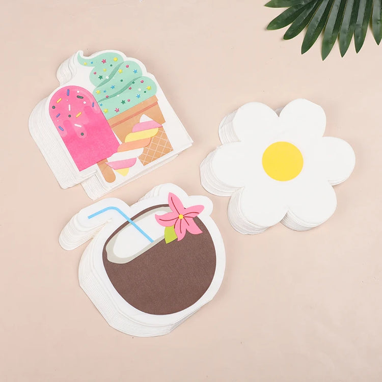 A set of cute paper napkins with summer-themed illustrations, including a popsicle, a flower, and a coconut drink, arranged on a light beige background with a green leaf in the corner.