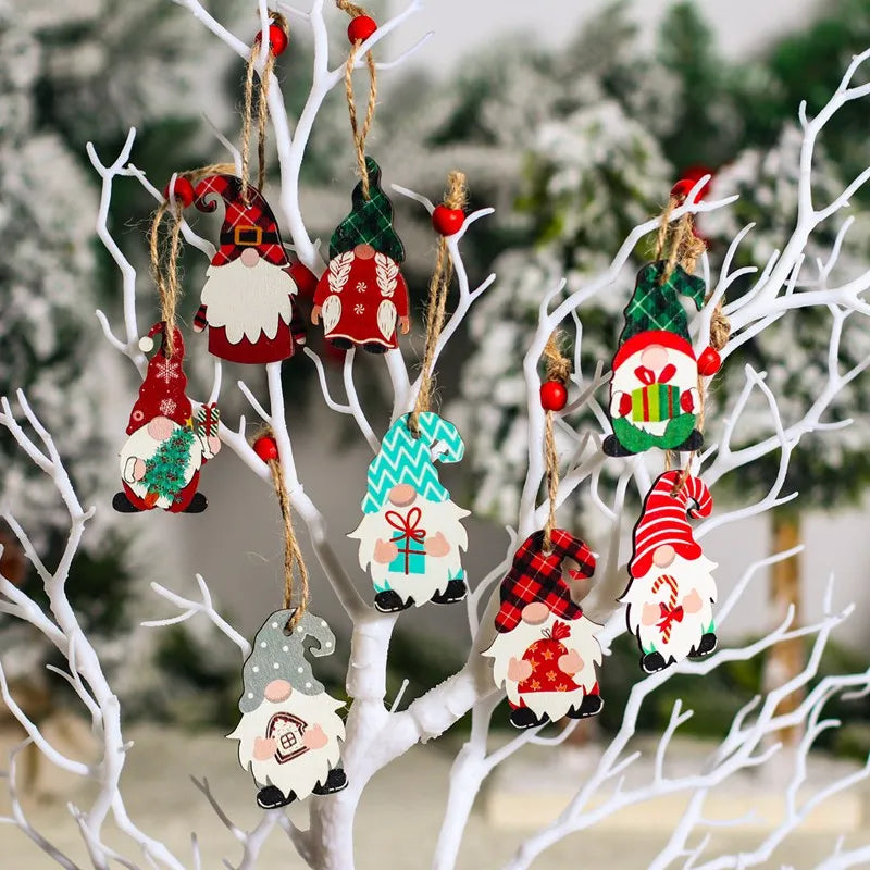 Colorful gnome Christmas ornaments with patterned hats and white beards hang from white branches on red-beaded cords.