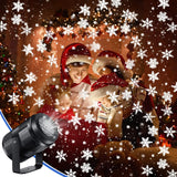 Black light projector beside a family wearing Santa hats, with white snowflake patterns across a warmly lit Christmas room.