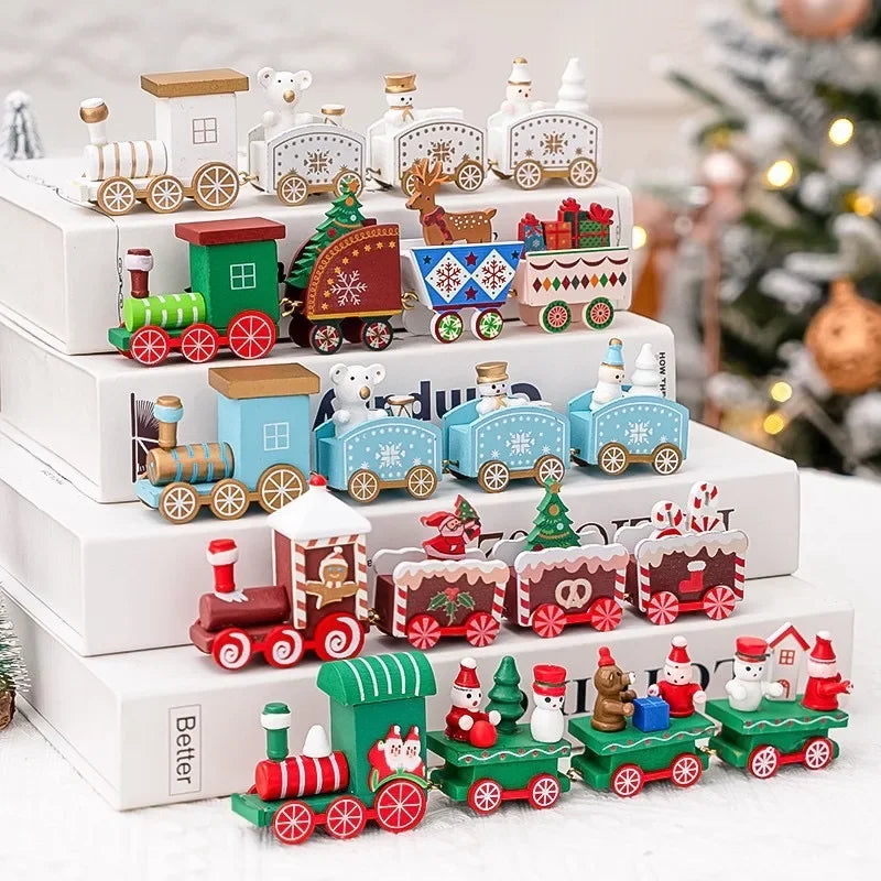 Christmas train decorations in white, blue, red, and green sit on stacked books with snowmen, trees, gifts, and reindeer figures.
