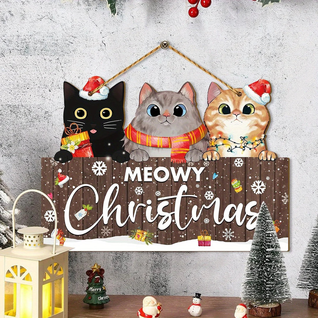 Brown Meowy Christmas hanging sign with three cats hangs on a textured white wall above a glowing lantern and miniature trees.