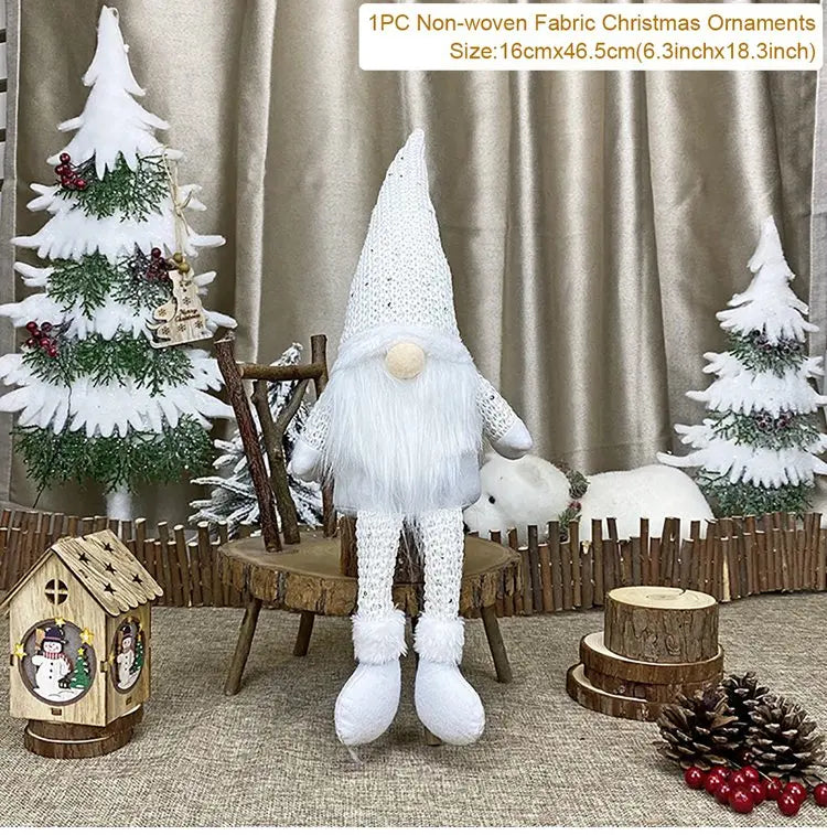 White gnome with dangling legs sits on a rustic chair among Christmas decorations, with a size label reading 16 × 46.5 cm.
